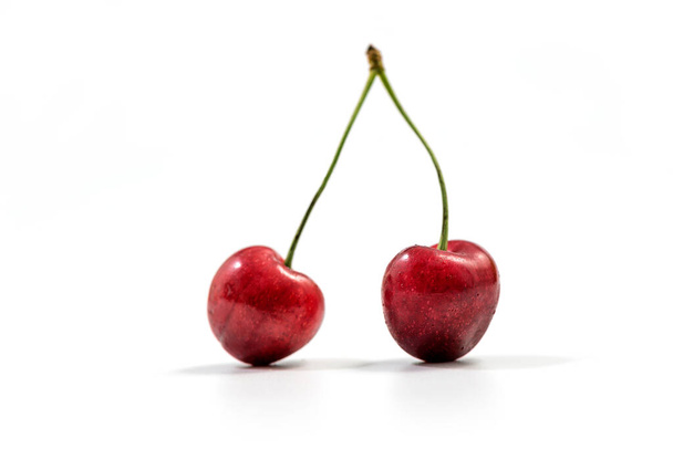 Fresh red cherry isolated on white. Cherry fruit with copy space for text. Sweet cherry isolated on white background cutout. Two fresh cherries on white background. - Foto, Bild