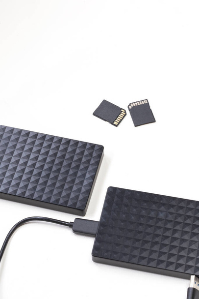 Storage device black external hard drive and sd Cards isolated on white background, Computer and Laptop storage concept - Photo, Image