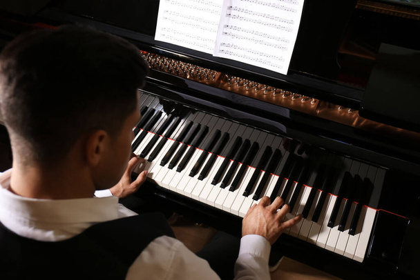 Man playing piano, above view. Talented musician - Fotó, kép