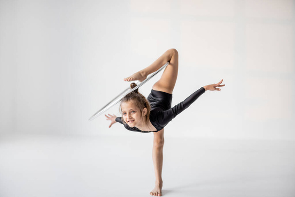 Girl practising rhythmic gymnastic with a ring - Φωτογραφία, εικόνα