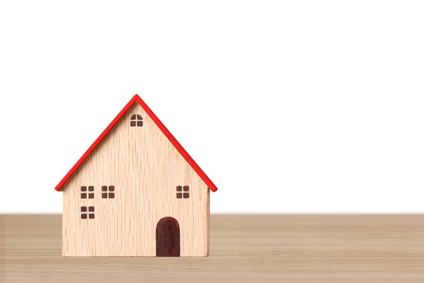 Концепция инвестиций в бизнес-недвижимость, модель деревянных домов на деревянном столе на белом фоне студия для финансовой рекламы недвижимости - Фото, изображение