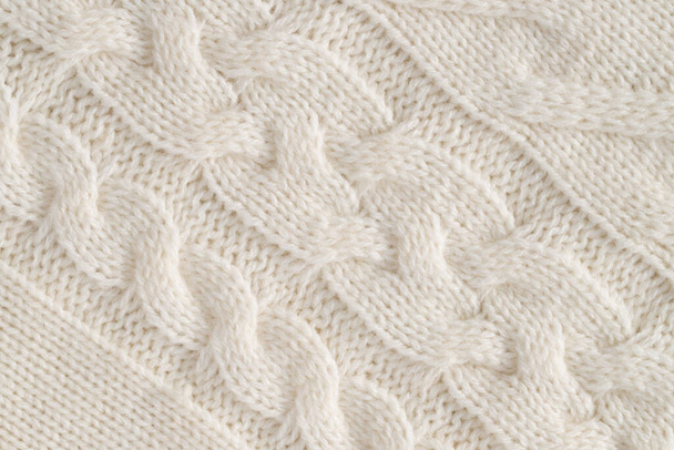 Background Of White Knitted Fabric Of Wool With Patterns Close Up. - Valokuva, kuva