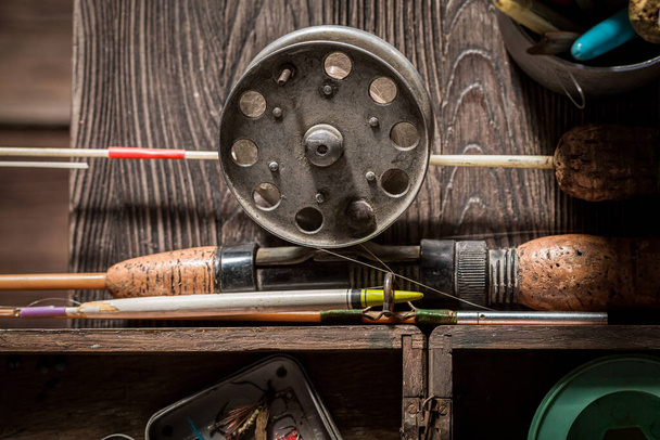 Vintage stuff for angler with rod and lures. Fishing equipment. Old wooden workshop fisherman. - Foto, afbeelding