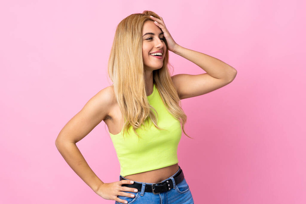 Young Uruguayan blonde woman over isolated pink background smiling a lot - 写真・画像