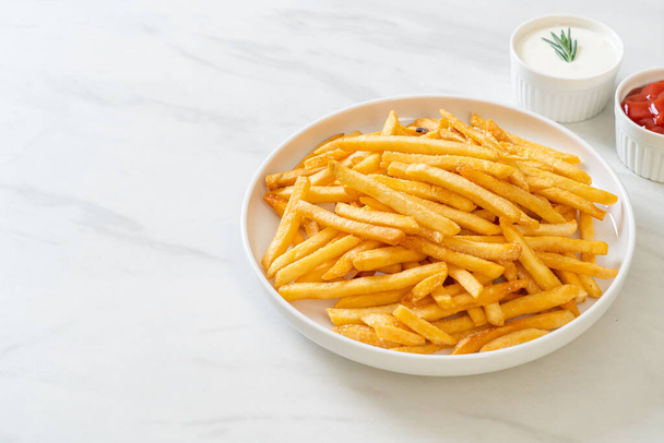 French fries or potato chips with sour cream and ketchup - Φωτογραφία, εικόνα