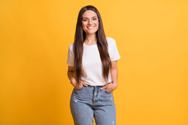 Photo of charming cheerful woman hold hands pockets wear casual outfit isolated on vibrant yellow color background - Φωτογραφία, εικόνα
