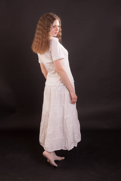 studio portrait of teenage girl on black background - Zdjęcie, obraz