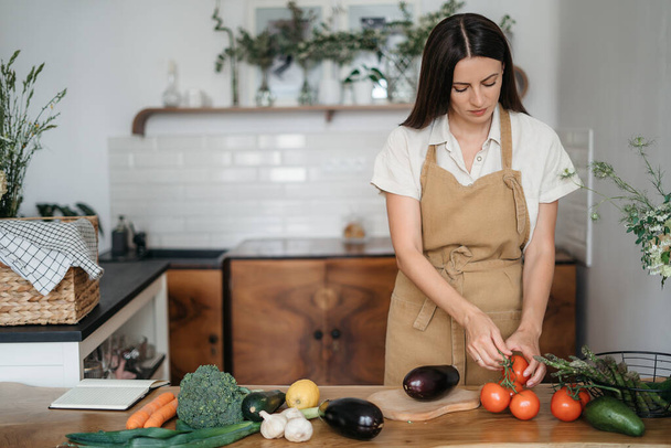 Young Woman Cooking in the kitchen at home. Healthy Food. Diet. Dieting Concept. Healthy Lifestyle. Cooking At Home. Prepare Food.A woman holding fresh organic vegetables in her hands - Zdjęcie, obraz