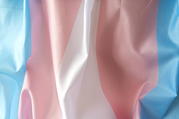 Transgender fabric flag with white, pink, blue strips. Close-up transgender pride flag as background or texture - Φωτογραφία, εικόνα
