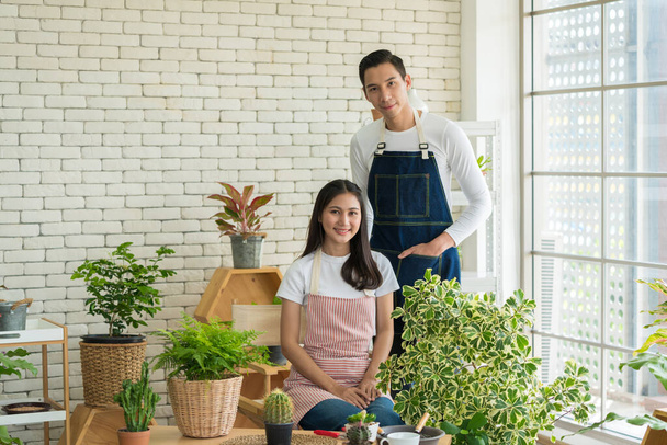 Portrait of Young Entrepreneur, Plant sellers opened the Online floral plant shop in the house. Florist or Gardeners working in a garden nursery. Ecommerce shopping, Small delivery business from home - Photo, Image