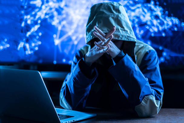 der anonyme Hacker, der die persönlichen Online-Daten in seinem Büro bremst, dunkelblau, Deep Web - Foto, Bild
