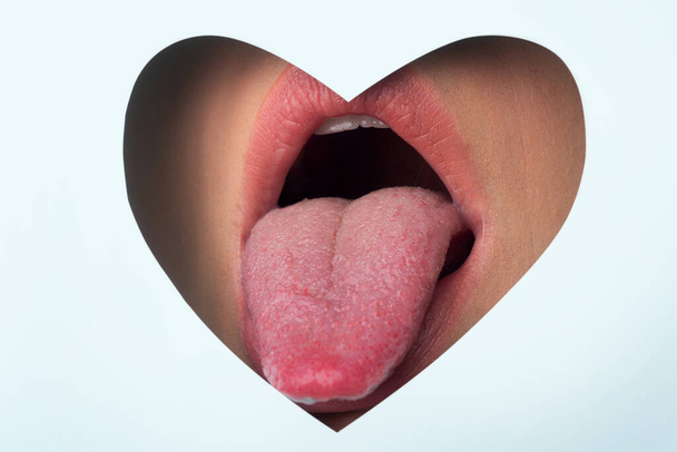 Valentine tongue on the mouth. Beauty lips with heart shape copy space. Valentines Day. Beautiful Love. - Foto, Bild