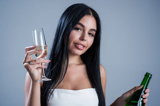 sexy woman drinking champagne from glass, birthday - Fotó, kép