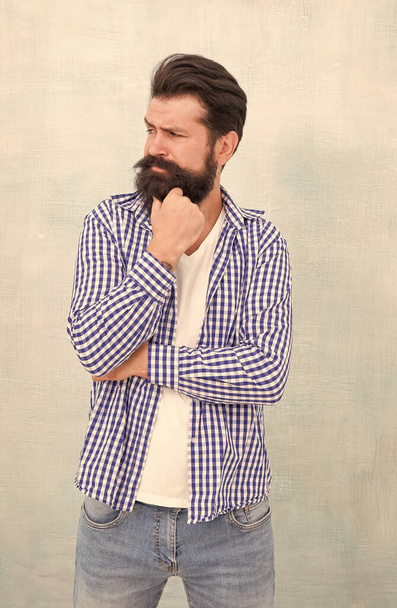 Lost in thoughts. Serious look of bearded man. Serious hipster with beard blue background. Solving problem. Dilemma. Thinking process. Barbershop. Hair salon. Casual style. Fashion wear - 写真・画像