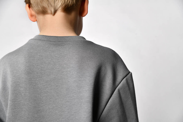 Close up detail of a sports hoodie dressed on a little boy. White background. - Valokuva, kuva