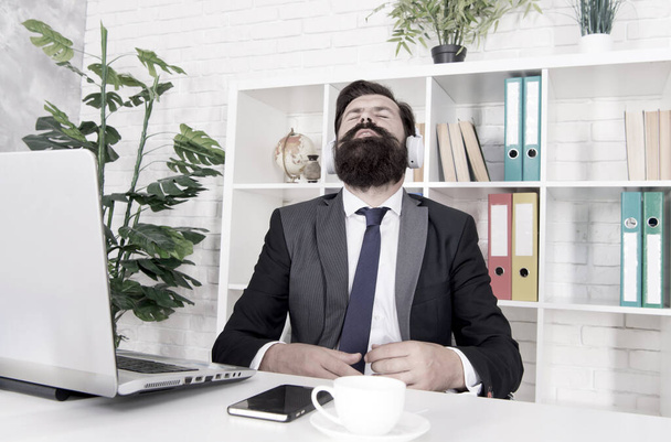 Give yoursel a break. Businessman relax during break time. Bearded man listen to music at work break. Employer in formal suit enjoy rest break. Rest and timeout. Music and relaxation - Foto, afbeelding