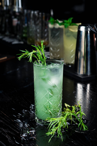 Estragon lemonade. Concept refreshing summer drinks. Fresh cool lemonade tarragon with ice - Photo, image