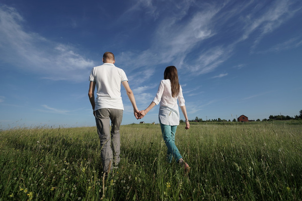couple walking through green field - Photo, image
