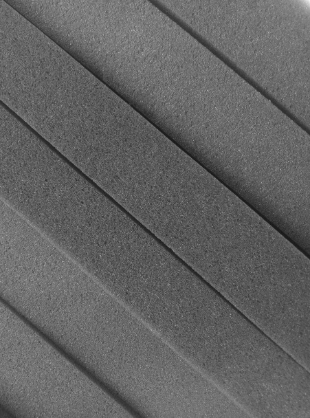grijs gestreepte sponsschuim achtergrond met ruw en poreus oppervlak - Foto, afbeelding