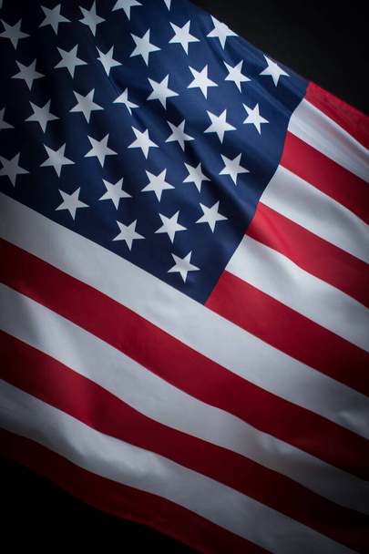 Closeup of waved USA flag over dark background - Photo, image