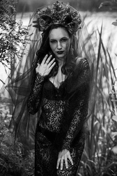 Black bride at water, Slavic rituals, pagan magic scene, old magic power concept - Foto, Imagen