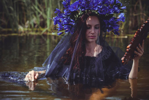 Black bride at water, Slavic rituals, pagan magic scene, old magic power concept - Photo, image
