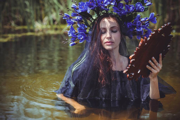 Black bride at water, Slavic rituals, pagan magic scene, old magic power concept - Photo, Image