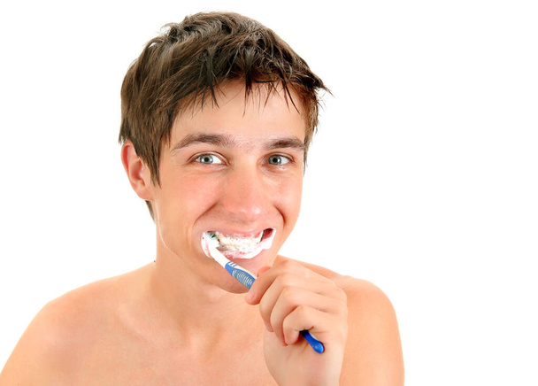 Happy Young Man brushing his Teeth Isolated on the White Background - Fotografie, Obrázek