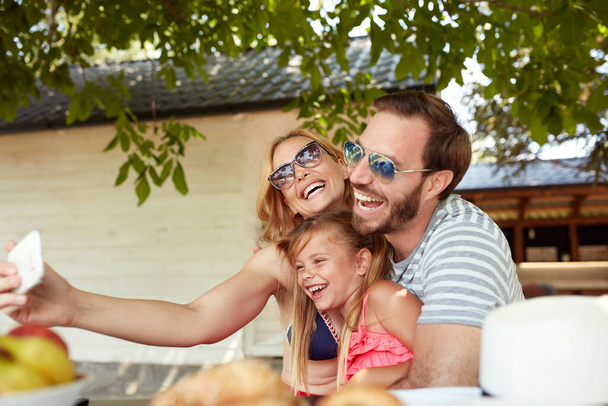 happy caucasian family laughing together while making selfie - Foto, afbeelding