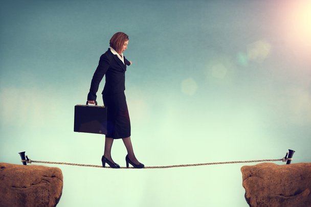 Businesswoman balancing on a tightrope - Photo, Image