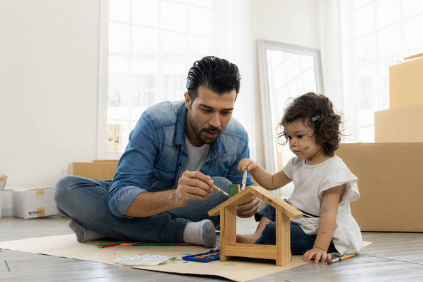 Apa és lánya festés színezés akvarell a faház gúnyolódik. Ülni a padlón a nappaliban. Boldog családi pillanatot a házban. Művészeti tevékenység az óvodában. - Fotó, kép