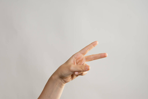 Hand gestures, Two thumbs up, a victory gesture. Womens hand - Foto, Imagem