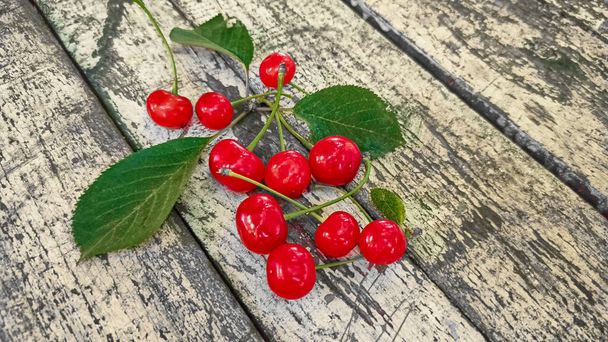 Fresh ripe red cherries on wood background. - Photo, Image