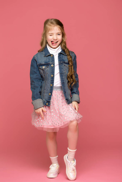 Cheerful little girl shows tongue, happy childhood concept - Foto, Imagen