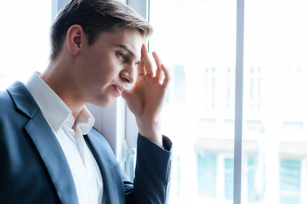 Young businessman get headache or He get sick during working at office or Sad man get problem from job Stressed fired employee thinking of future life Unemployment Job loss Business problem concept - Фото, зображення