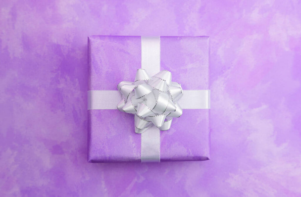 A Single Simple Wrapped Present on a Matching Background - Photo, Image