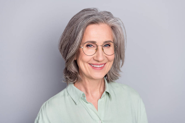 Photo of happy smiling cheerful beautiful mature smart businesswoman in glasses isolated on grey color background - Valokuva, kuva