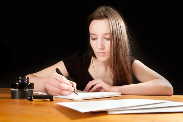 Pretty young woman writing a letter - Photo, Image