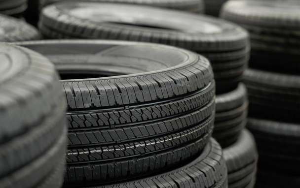Pile of tires stack in warehouse waiting to transport to distributors, new car tyres product in manufacturing factory background - Photo, Image