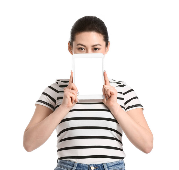 Young woman with tablet computer on white background - 写真・画像