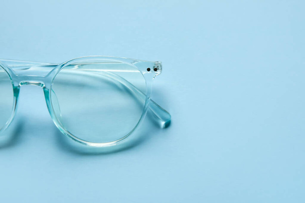 Stylish eyeglasses on color background, closeup - 写真・画像