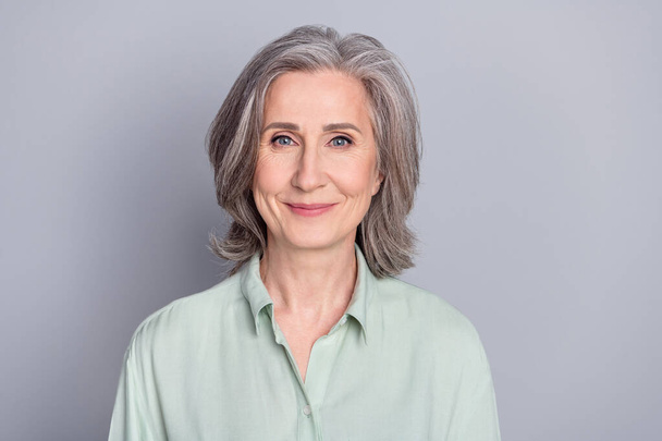Photo of mature positive smiling beautiful businesswoman secretary wear green shirt isolated on grey color background - Φωτογραφία, εικόνα