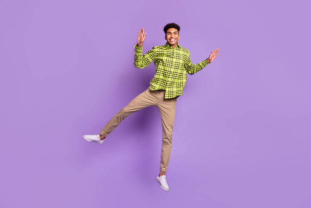 Full length body size view of nice carefree cheerful guy jumping having fun good mood isolated on violet purple color background - Fotoğraf, Görsel