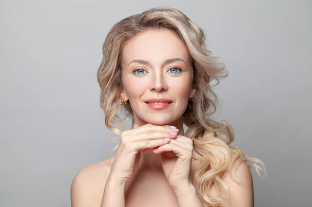 Beautiful woman with healthy skin and natural manicure nails on white background - Fotó, kép