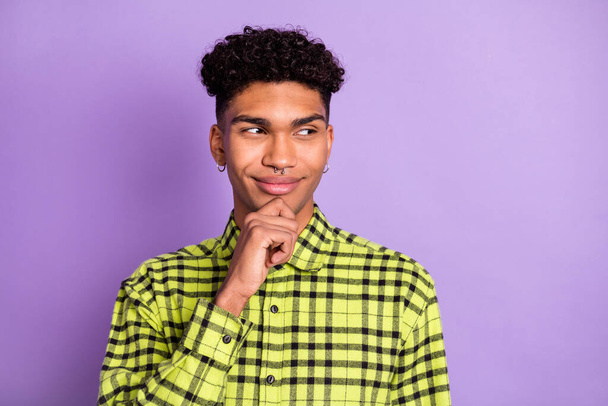 Portrait of attractive minded suspicious cheerful guy thinking deciding copy space isolated over violet purple color background - Фото, изображение