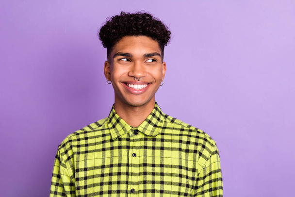 Photo portrait of guy curious looking blank space in checkered shirt isolated on pastel purple color background - Fotografie, Obrázek