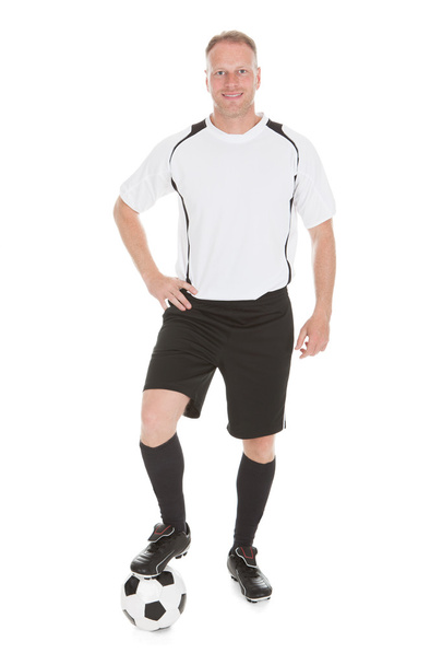 Player With Leg On Soccer Ball - 写真・画像
