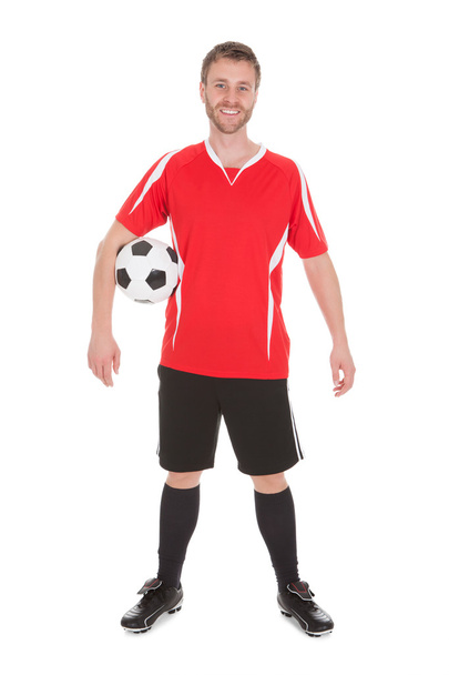 Soccer Player Holding Football - 写真・画像