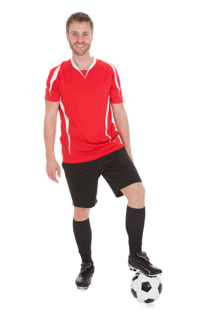 Player With Leg On Soccer Ball - 写真・画像