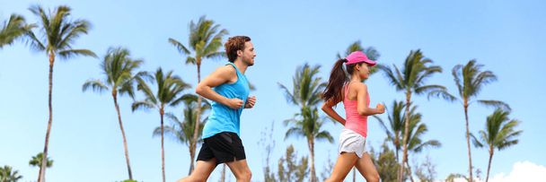 Healthy runners couple running lifestyle banner. Sport fitness people jogging together in summer park outdoors. Horizontal landscape with palm trees background - Foto, immagini